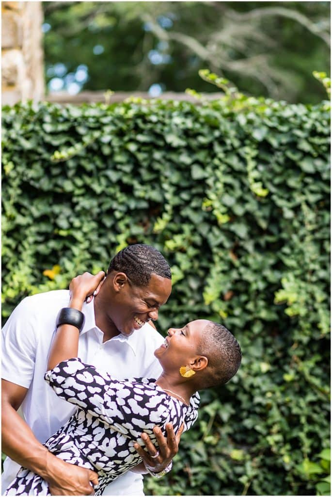 Man dipping woman in gardens engagement session portrait at Hunting Hill Mansion at Ridley Creek State Park