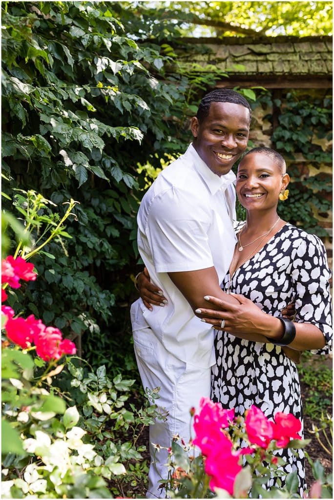 Traditional engagement portrait through flowers and greenery at Hunting Hill Mansion at Ridley Creek State Park