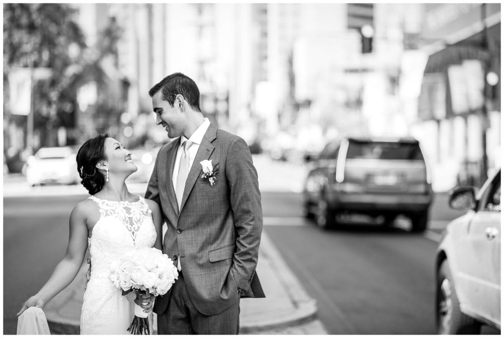 Black and white bride and groom wedding portrait in city streets of Philadelphia