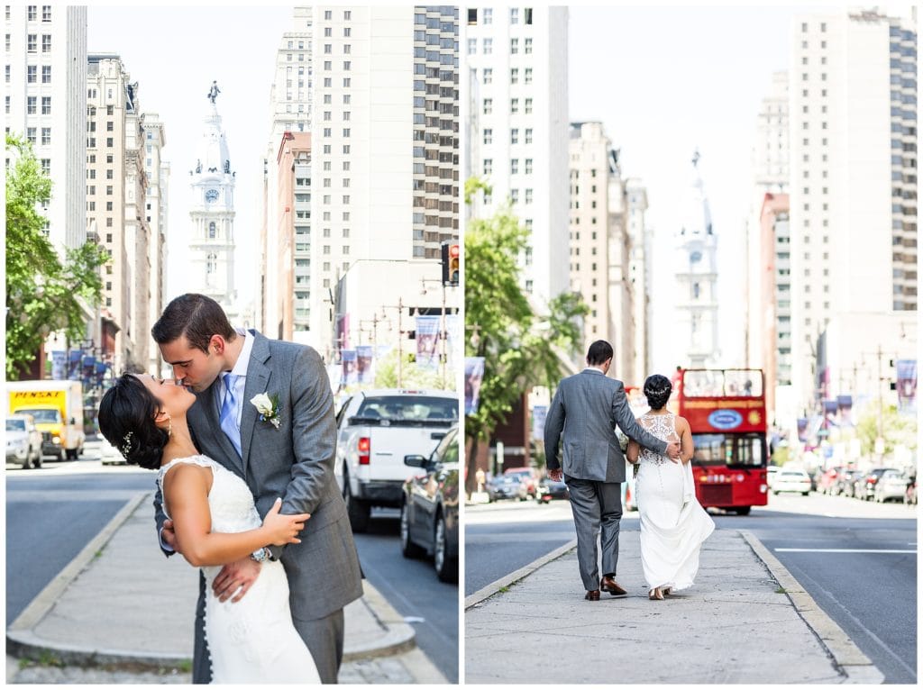 Groom dipping and kissing bride on Broad Street in front of City Hall Philadelphia wedding portrait