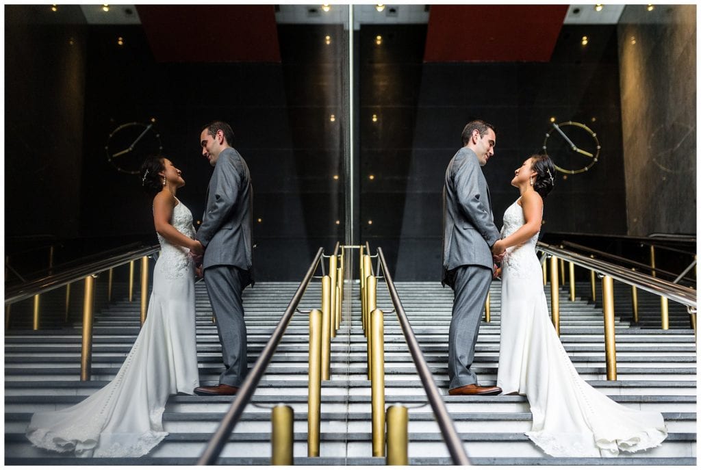 Traditional bride and groom reflection portrait on stairs at Loews Philadelphia wedding