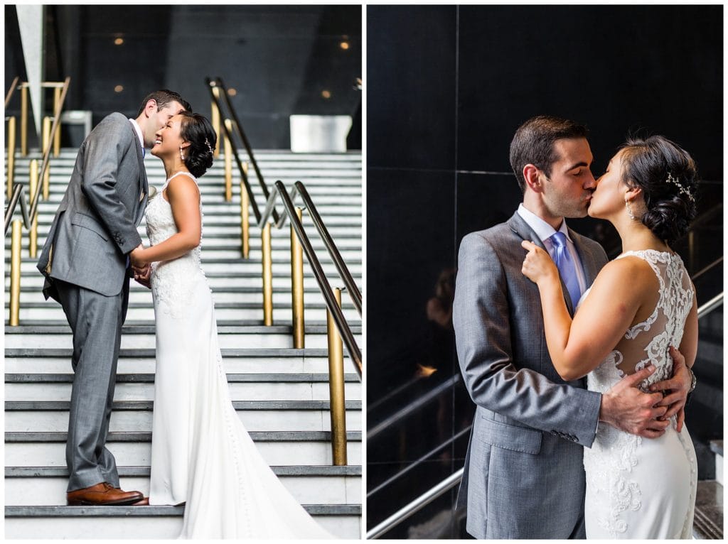 Groom whispers in brides ear and bride and groom kissing on stairs at Loews Philadelphia wedding