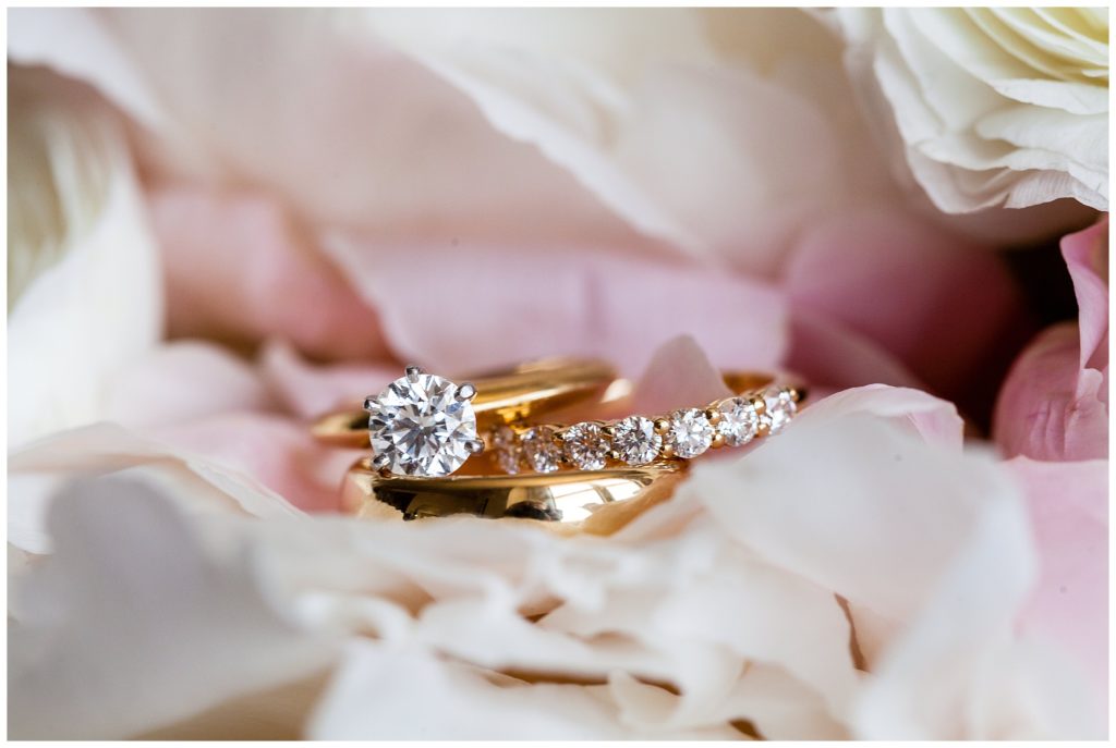 Diamond gold wedding and engagement rings in pink and white flower petals