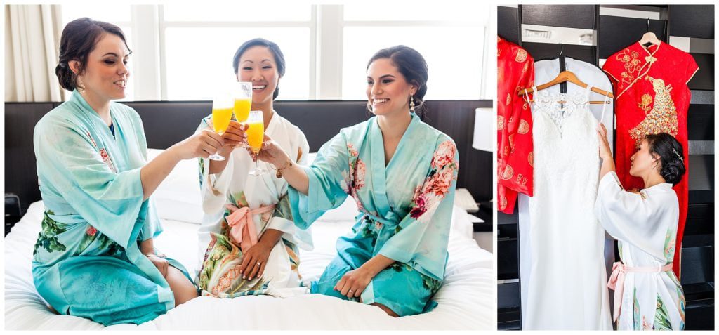 Bride sharing mimosa toast with bridesmaids in matching robes with bride looking at her wedding dresses