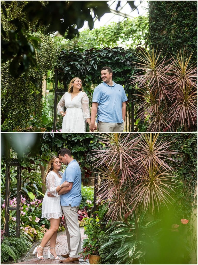 Couple holding hands and hugging in bushes at Longwood Gardens engagement session