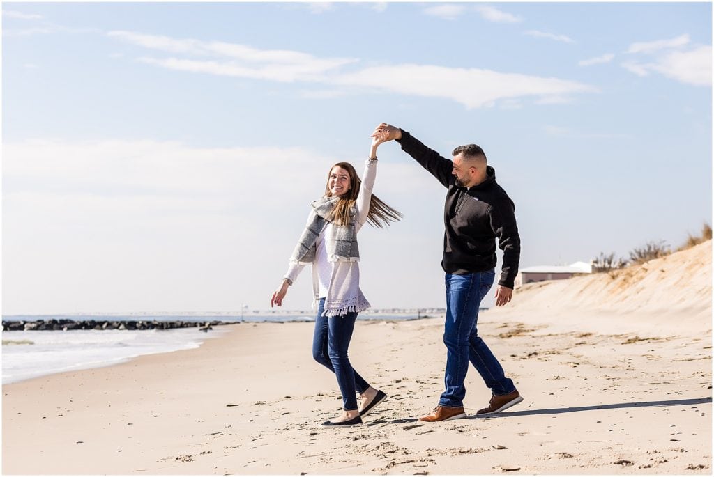 Groom spinning bride engagement portrait at Ocean City New Jersey beach session