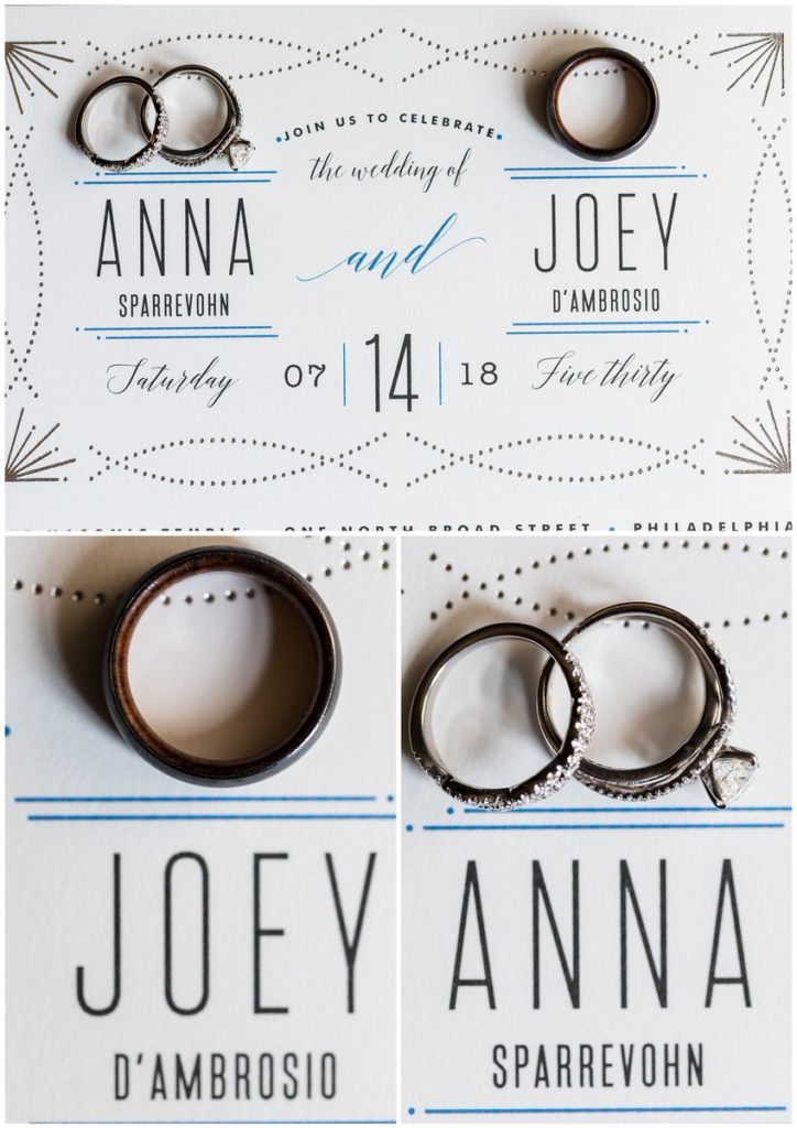 Silver and blue geometric wedding invitation suite with wedding bands and engagement rings next to bride and groom names