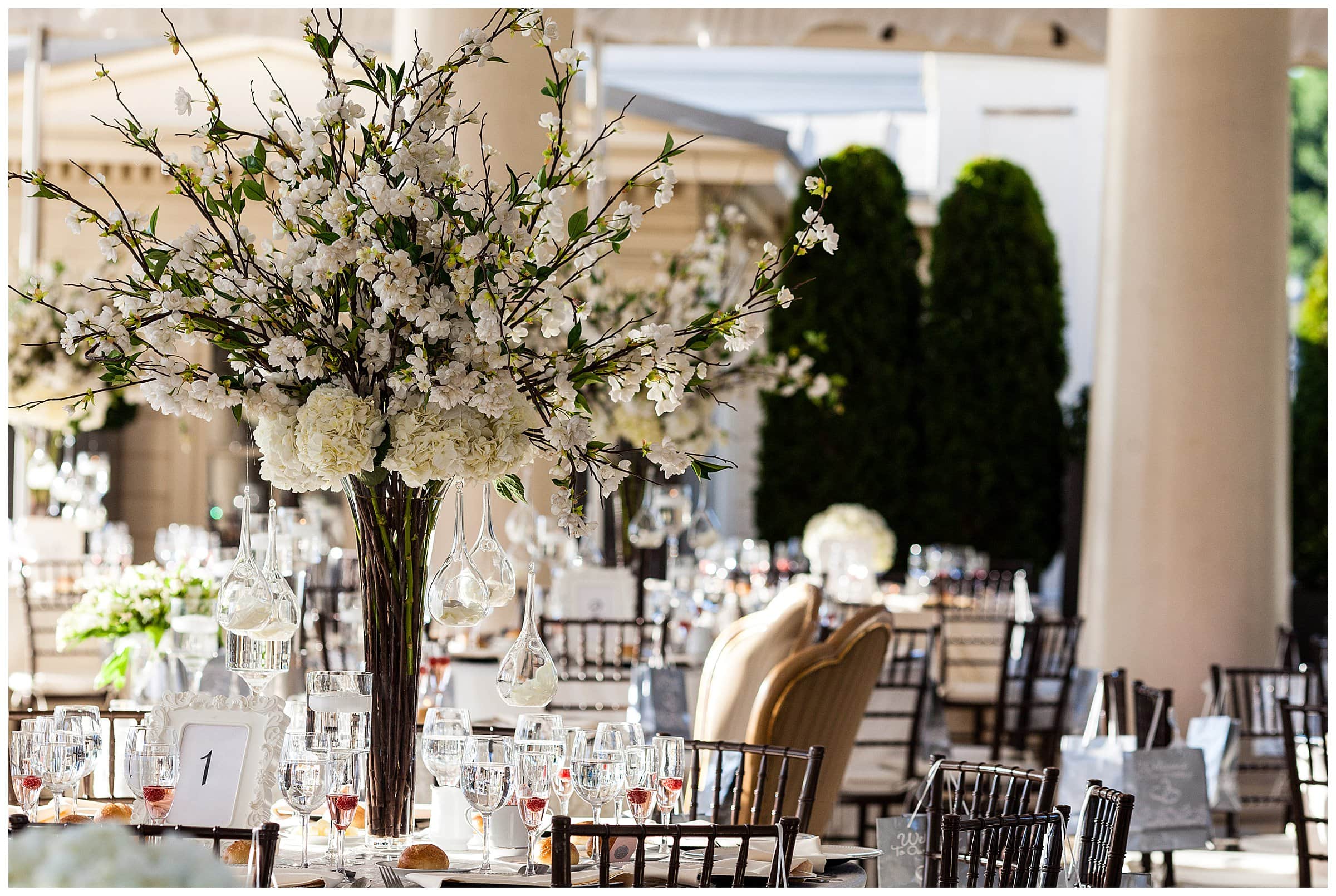 Tall white floral centerpiece with hanging candles at Waterworks Philadelphia wedding reception