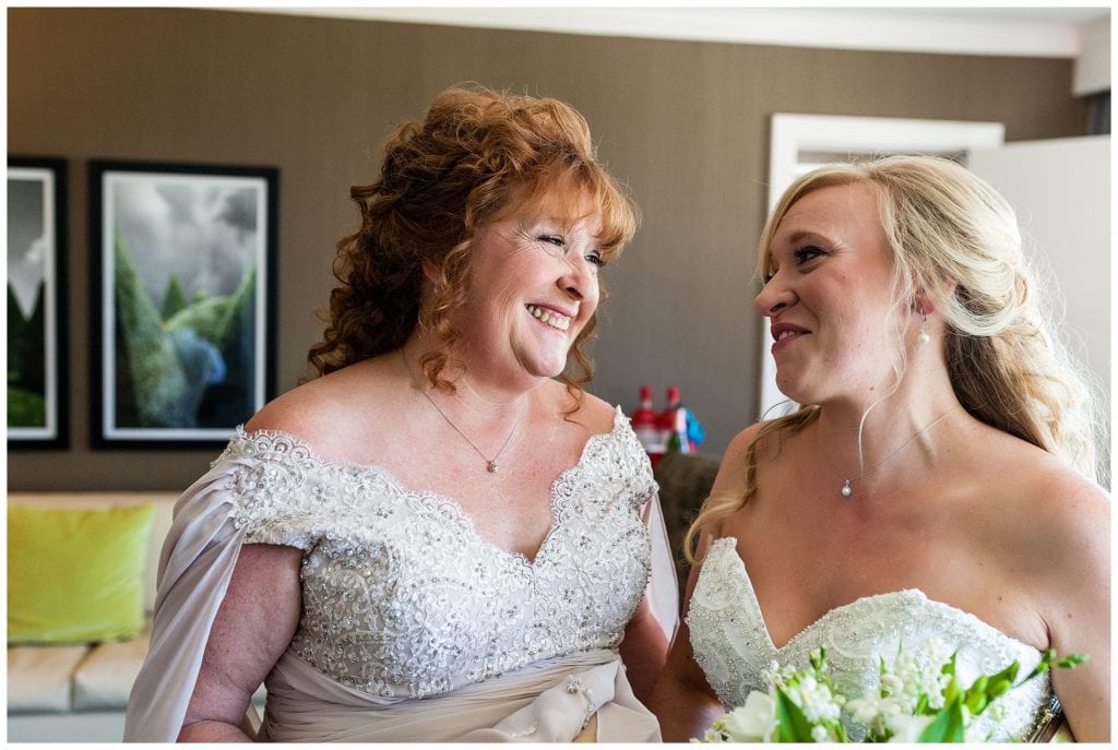 Bride and mother of the bride laughing