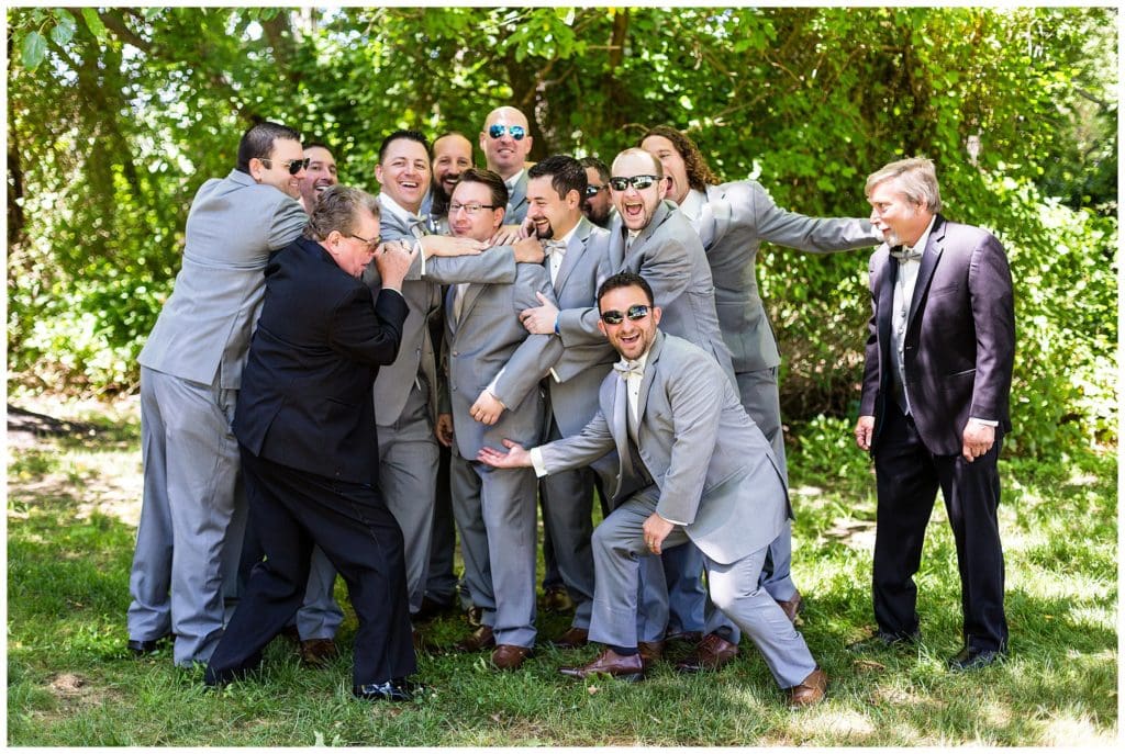 Funny groomsmen group hug portrait