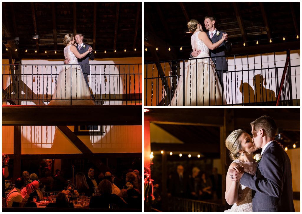 Bride and groom first dance in spotlight on balcony at Barn on Bridge winter holiday wedding reception