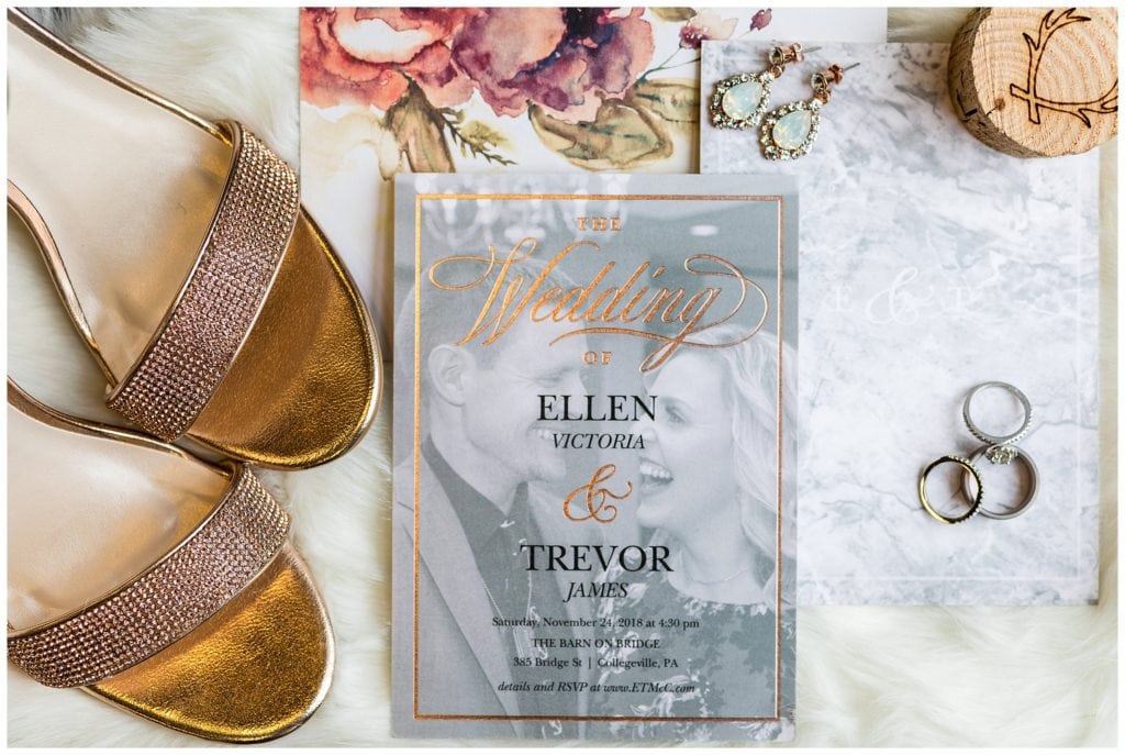 Gold wedding invitation with engagement portrait background, gold bridal heels, and bridal jewelry