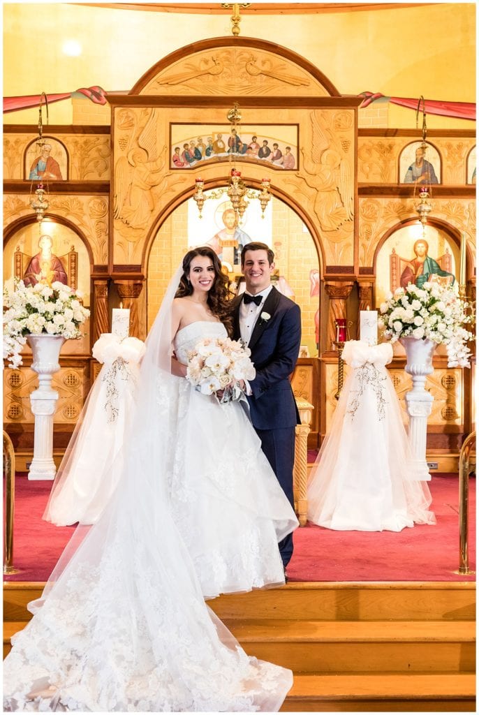 Traditional bride and groom portrait at alter in church wedding ceremony