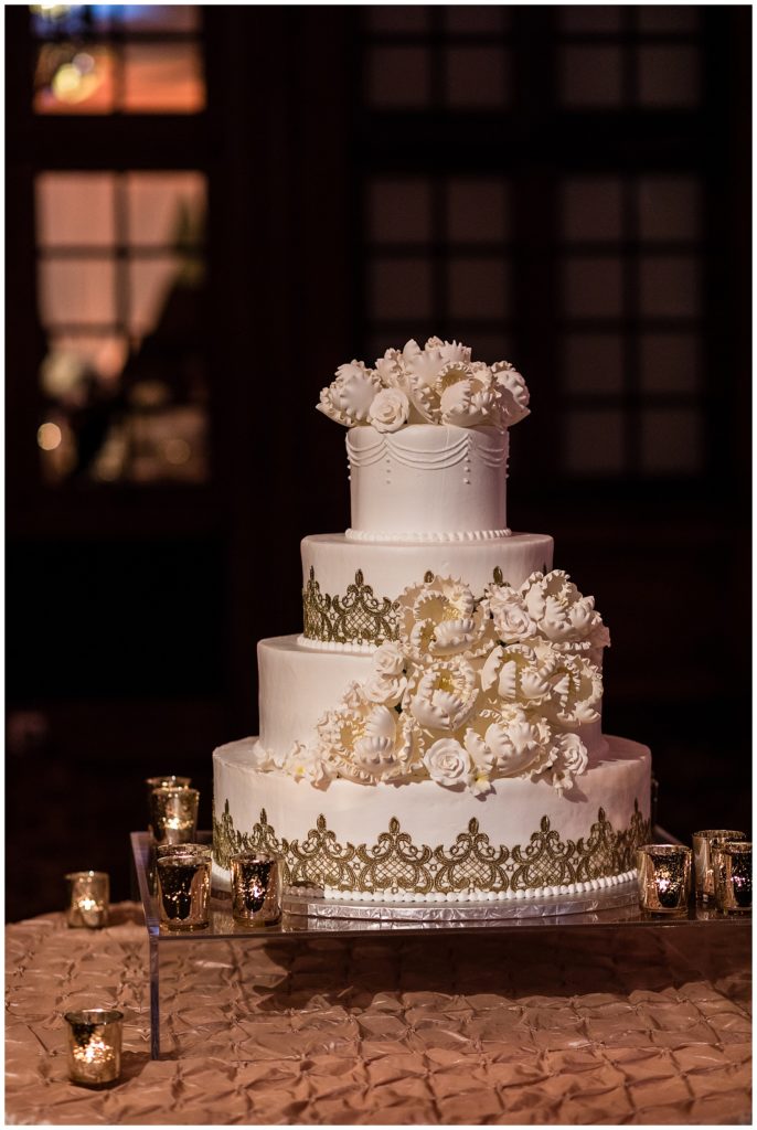 Elegant wedding cake with edible white flowers and gold pattern at Crystal Tea Room wedding reception