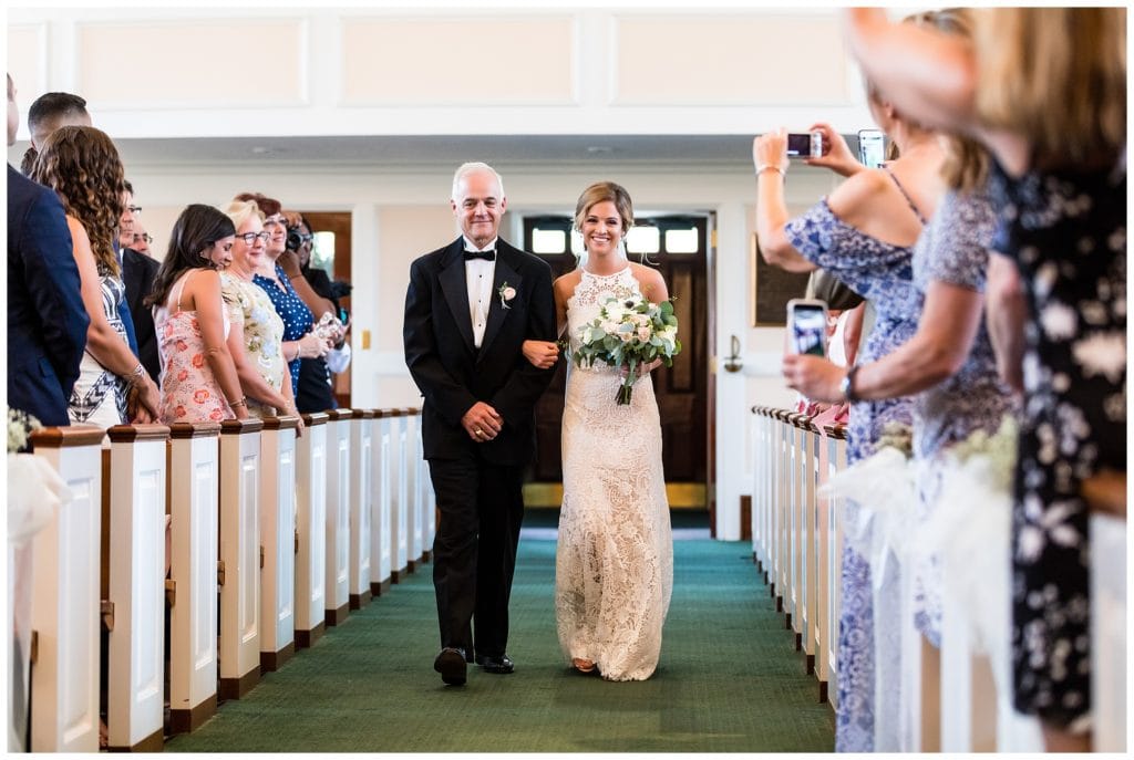 Bride and her father walking down aisle at St. James Roman Catholic Church wedding ceremony
