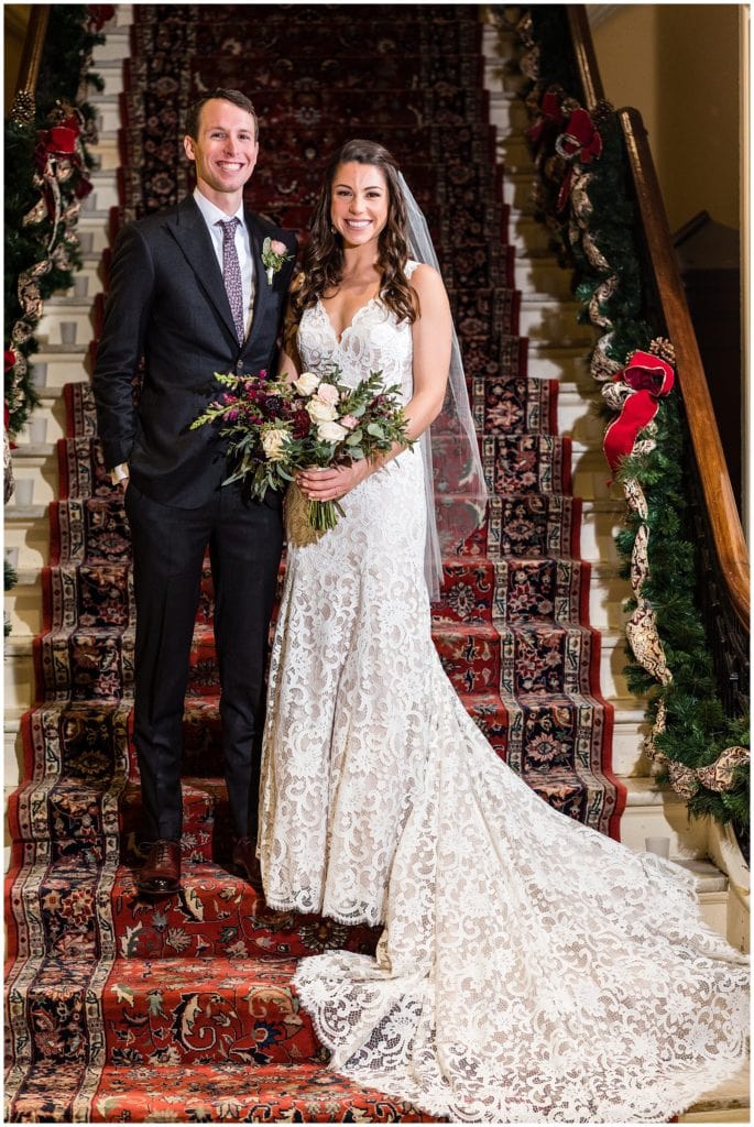 Traditional bride and groom portrait on staircase at Racquet Club of Philadelphia winter holiday wedding