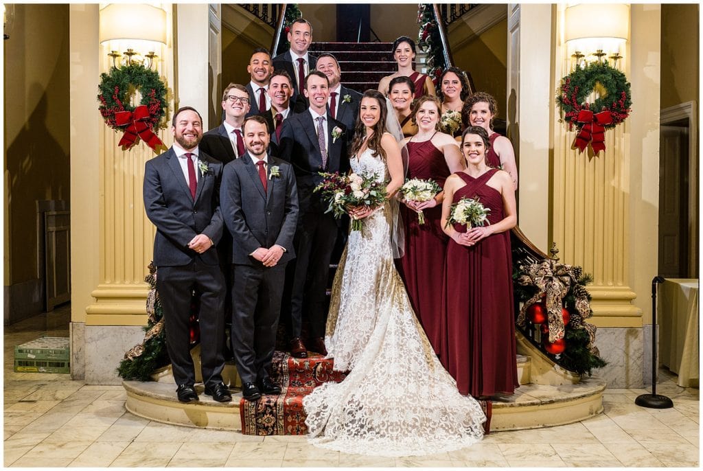 Traditional wedding party portrait on staircase at Racquet Club of Philadelphia winter holiday wedding
