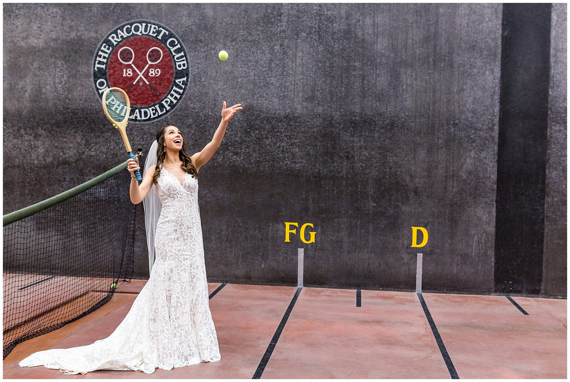 Bride swinging racquet on court at Racquet Club of Philadelphia winter holiday wedding