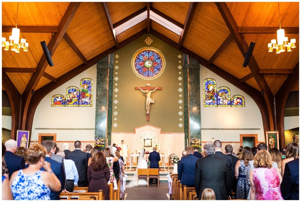 Bride and groom standing at alter in St. Andrew's Church wedding ceremony