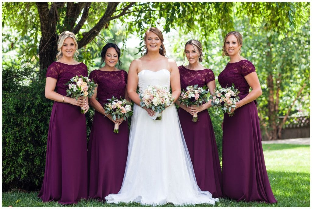 Traditional bridal party portrait with maroon bridesmaids dresses