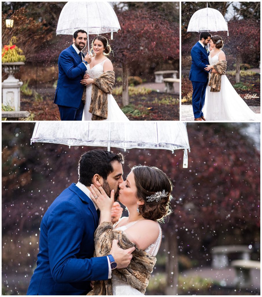 Bride and groom under umbrella in snow at Winter Radnor Hotel wedding