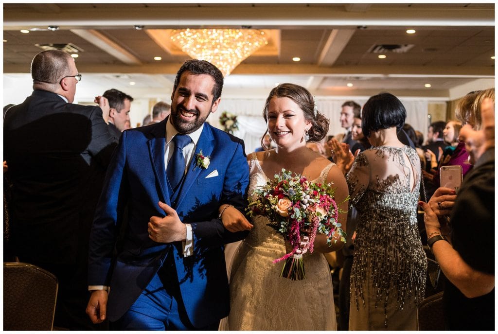 Bride and groom walk up aisle at Radnor Hotel wedding ceremony