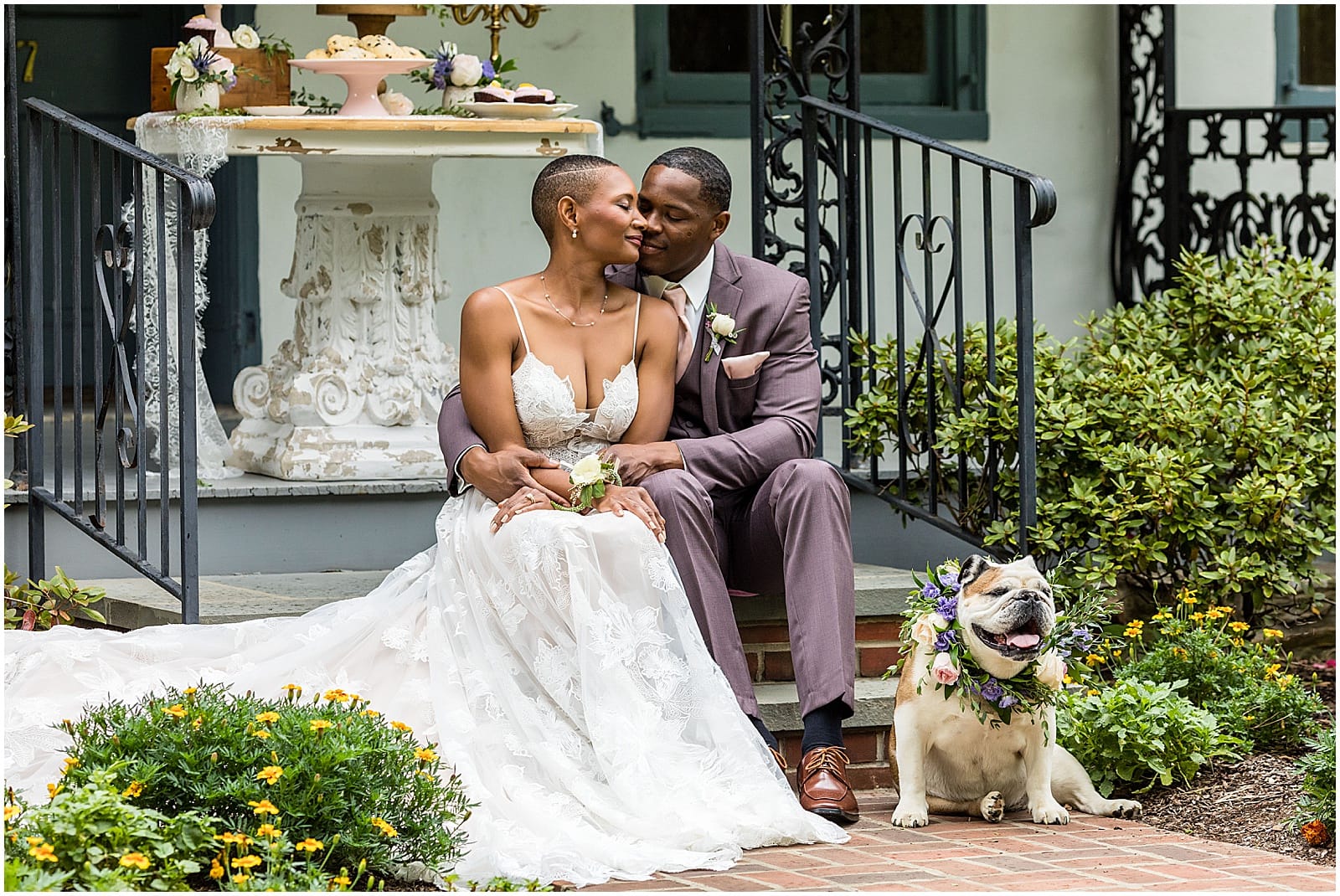 Bride and groom sit together with their dog on front steps at Duportail House wedding