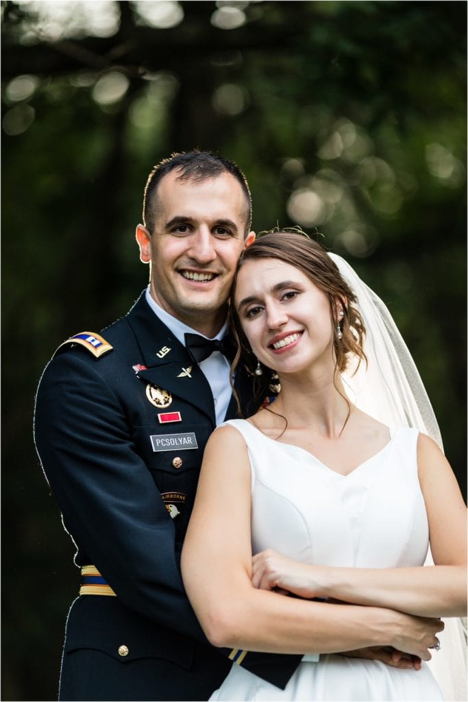 Traditional portrait of groom holding bride around waist at Mountain Springs Lake Resort wedding