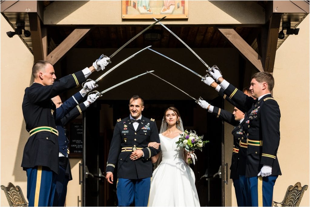 Armed Forces form Saber Arch for bride and groom to exit church after traditional Holy Trinity Orthodox wedding ceremony