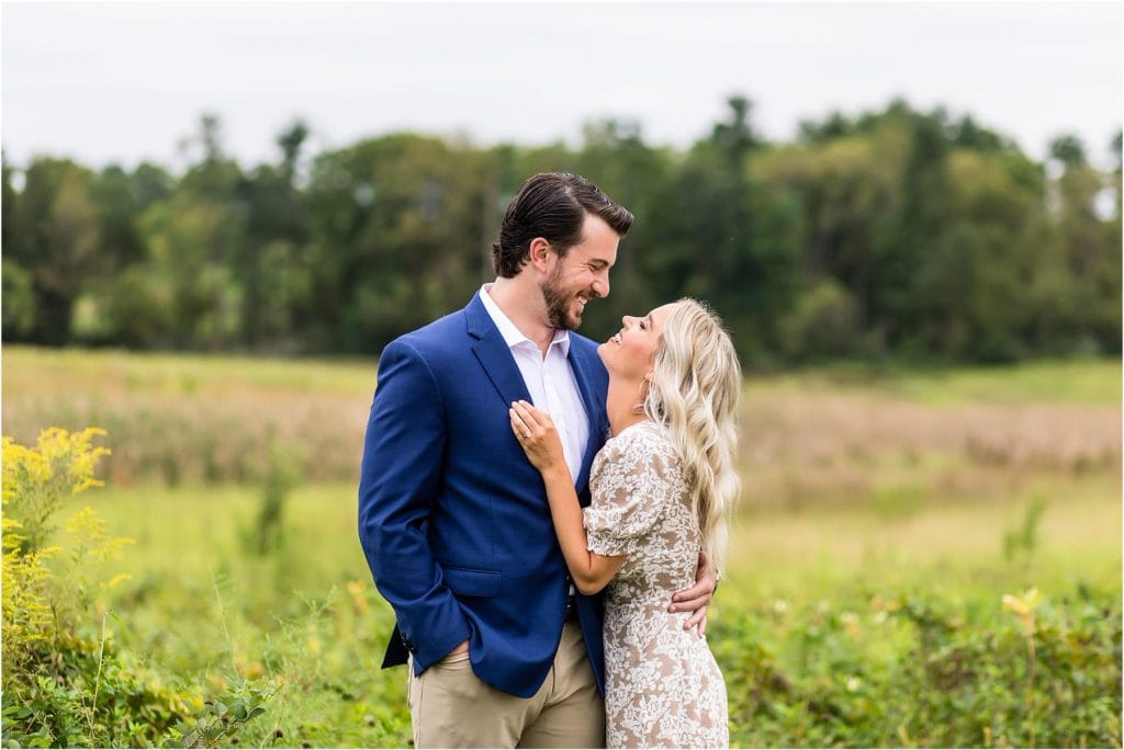 PHL17 Anchor engagement session in Valley Forge Park field hugging fiancé