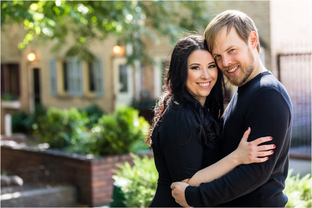 Traditional engagement photo of couple hugging and smiling in Center City Philadelphia neighborhood