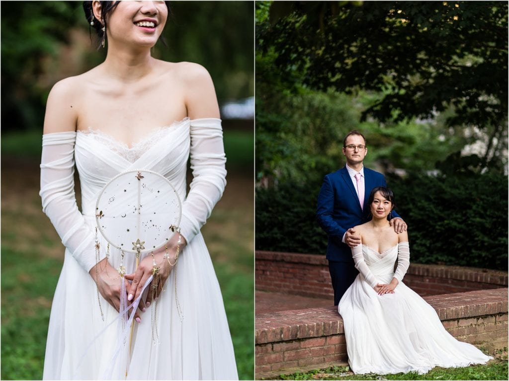 Bride holding dreamcatcher bouquet detail with portrait of groom standing behind bride sitting on brick wall in Old City Philadelphia