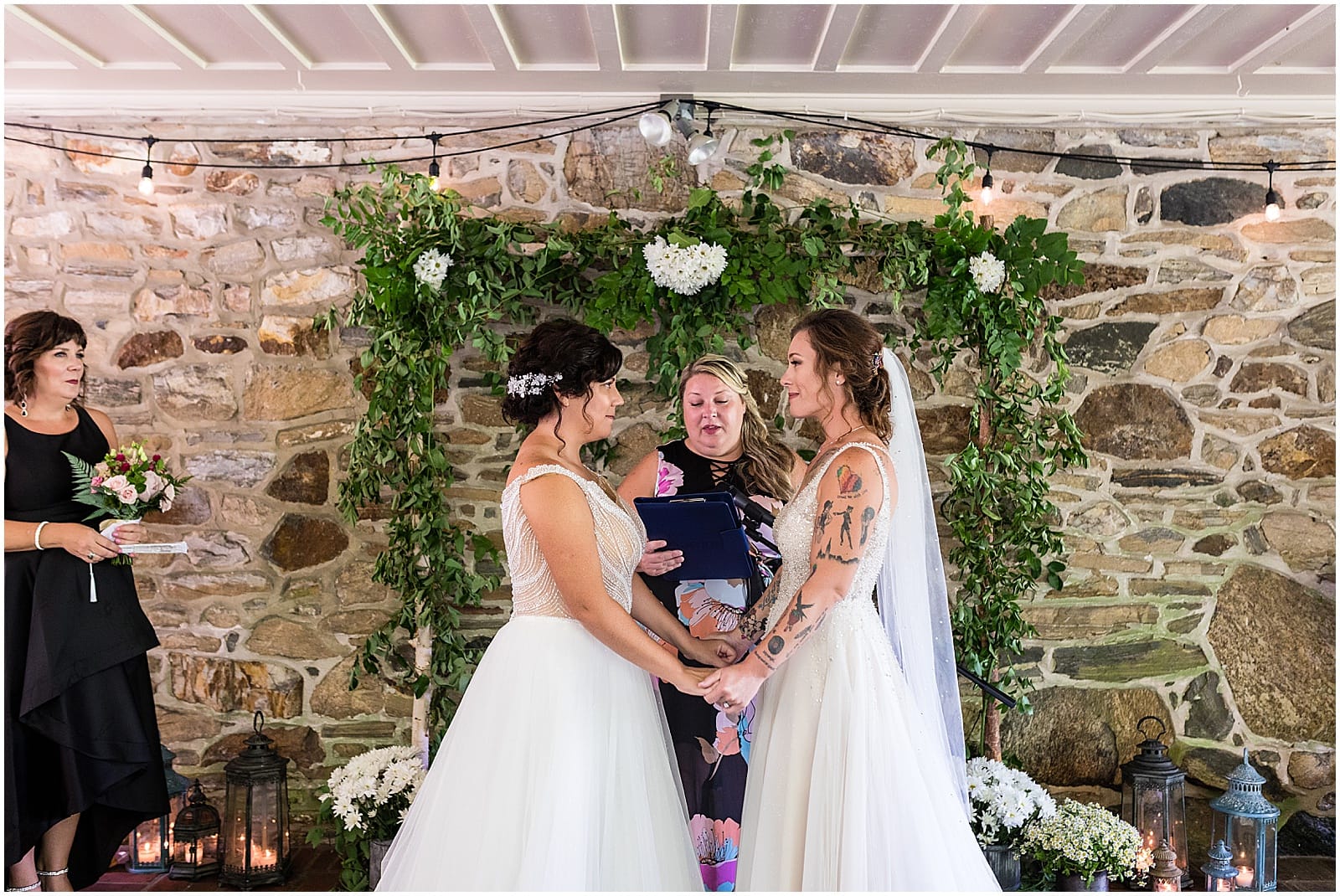 Brides hold hands at alter in Bolingbroke Mansion same sex wedding ceremony