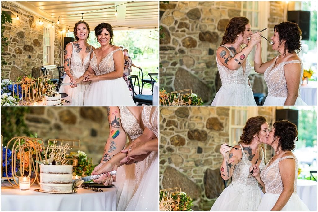 Brides cut cake, feed a piece to each other, and kiss after during reception at Bolingbroke Mansion pride wedding