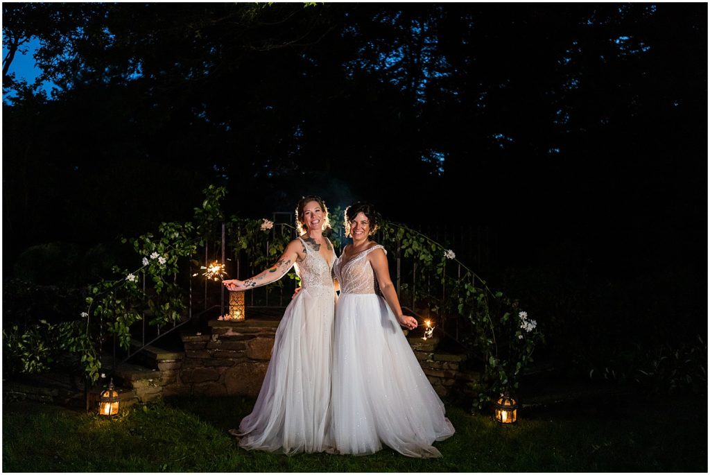 Brides hold sparklers in gardens of Bolingbroke Mansion