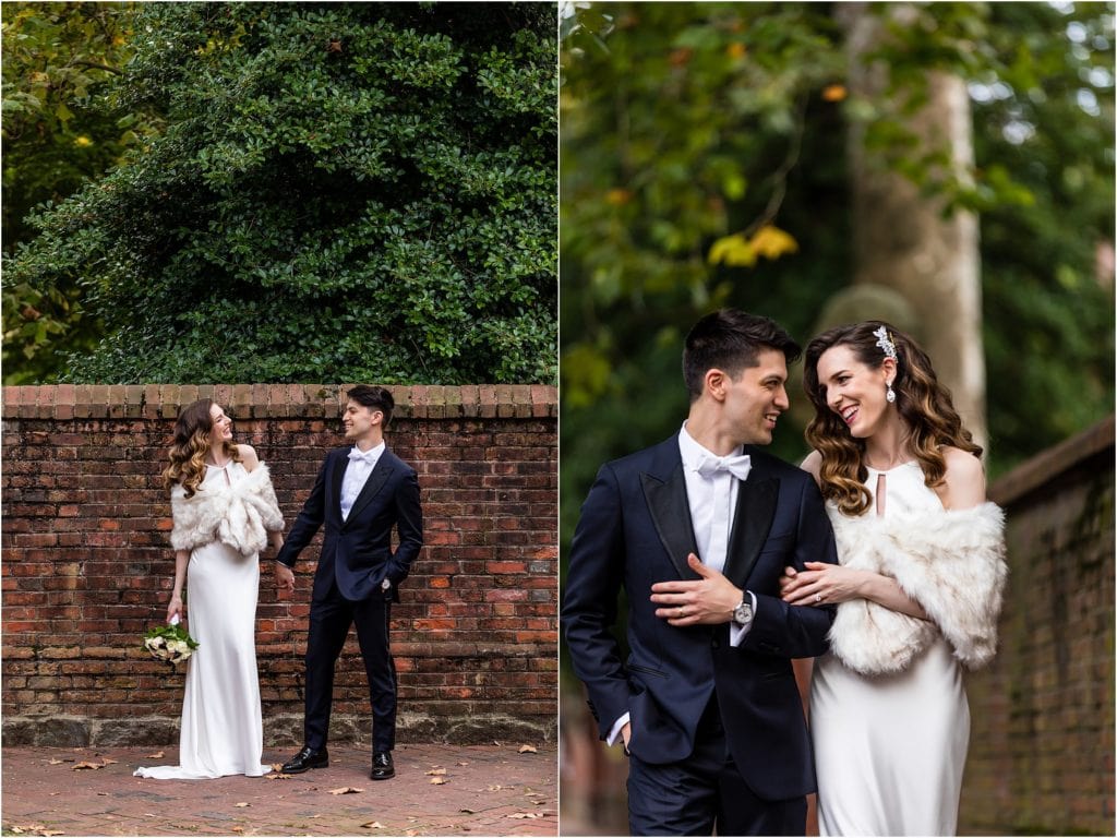 Bride and groom hold hands and smile and each other and bride and groom walk through cemetery after Society Hill elopement