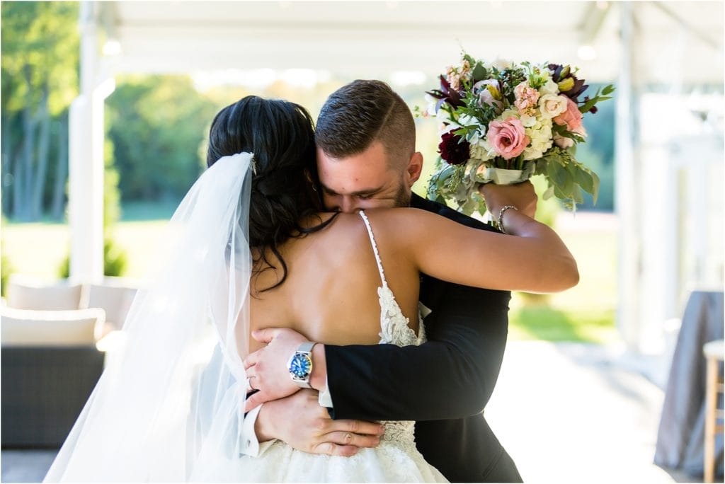 Bride and groom hug tightly after wedding ceremony at Pen Ryn Estate