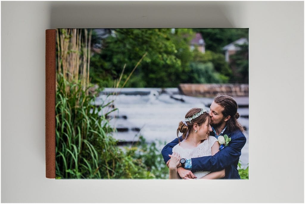 textured brown linen bound wedding album with image of bride and groom on the cover