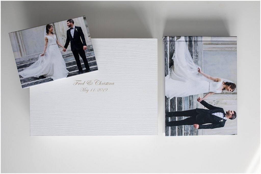 wedding album collection featuring a keepsake white woodgrain box with gold foil debossing and a large and small parent album