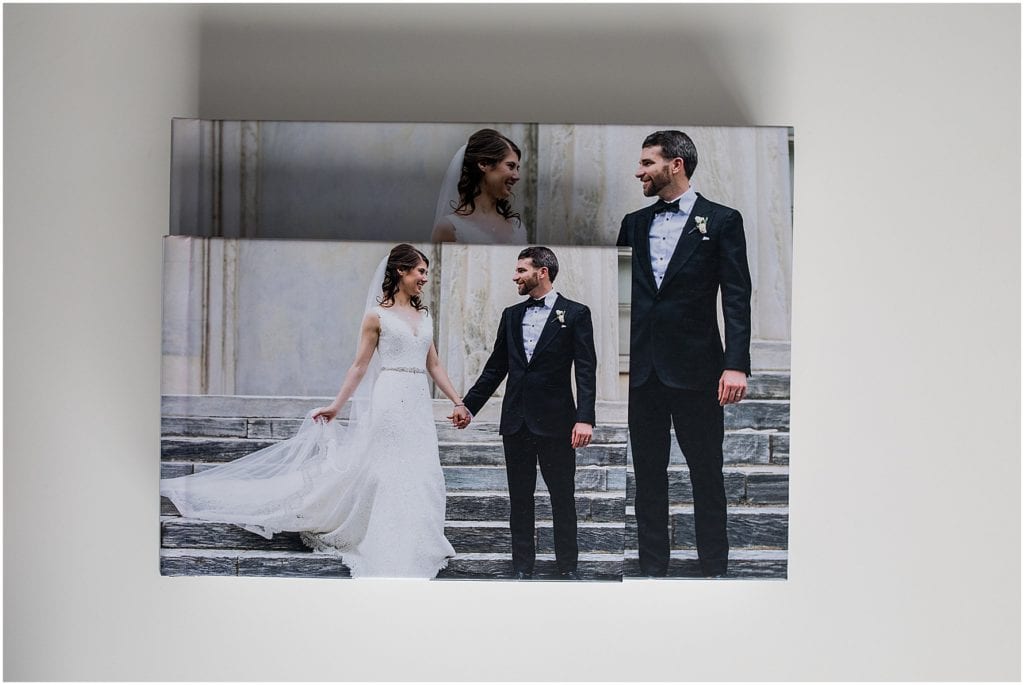 small and large parent wedding albums stacked on top of each other to show size difference