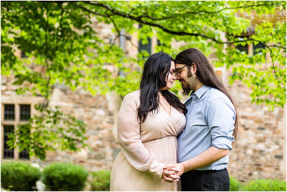 Couple leans together and touches foreheads in Ridley Creek State Park