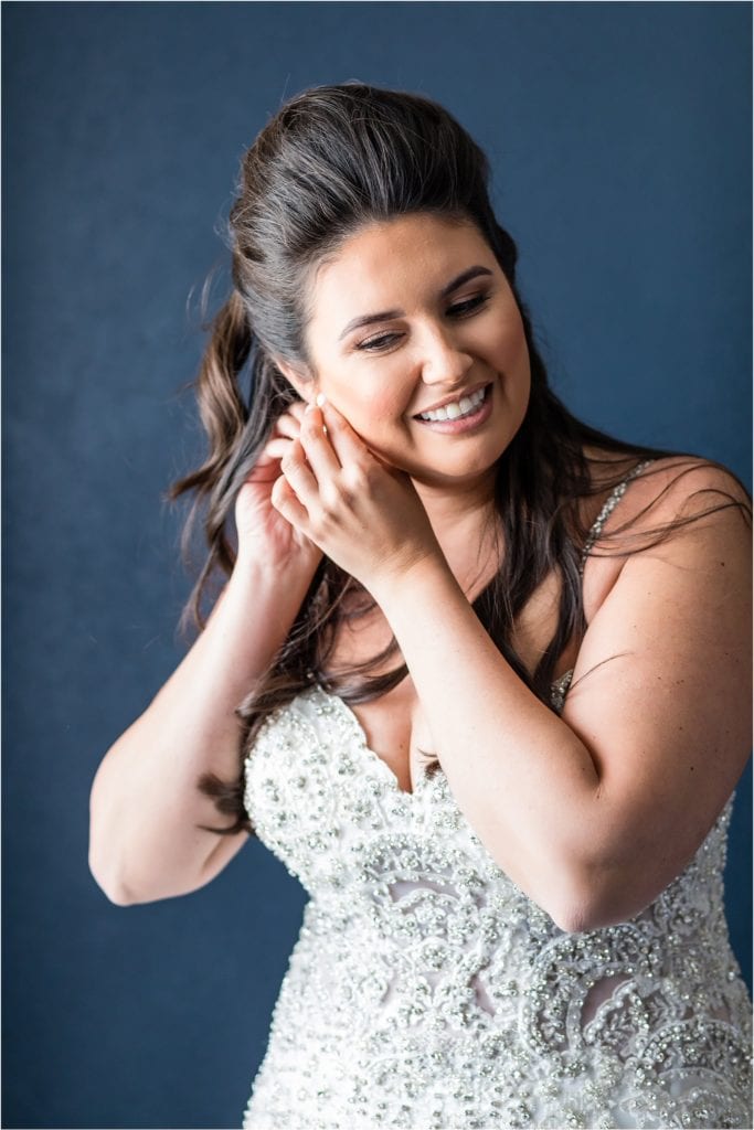 Bride putting her earrings in