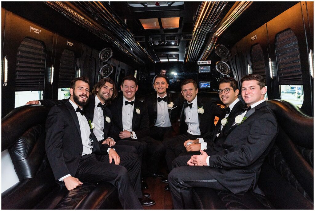 Groom and his wedding party inside a car 