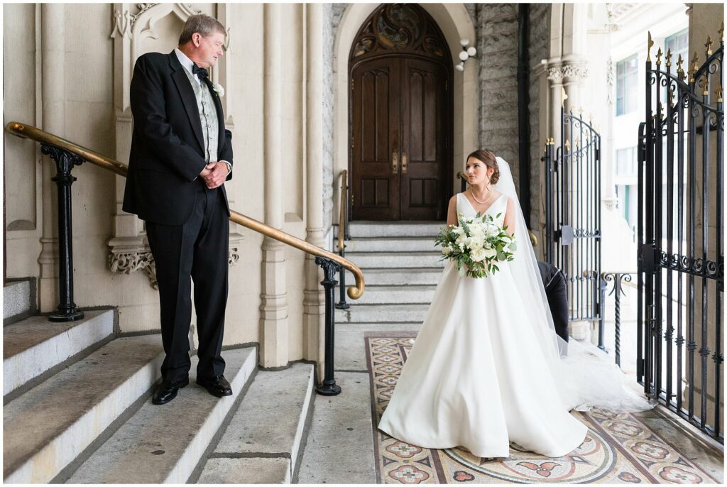 Bride meets her father before they walk down the aisle towards her groom