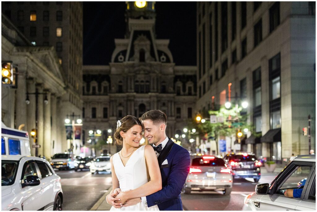 Newlyweds in the median of Broad St with the iconic City Hall of Philadelphia in the background