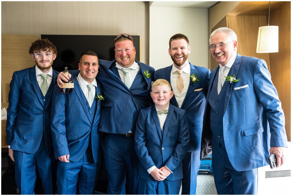 Groom smiles with his wedding party
