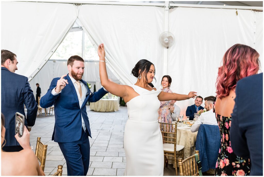 Bride and groom dance as they enter their wedding reception