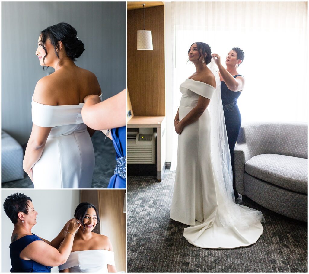 Bride is assisted with her dress and accessories