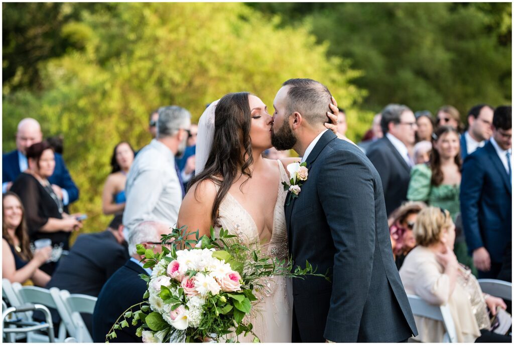 Bride and Groom kiss as they leave wedding ceremony