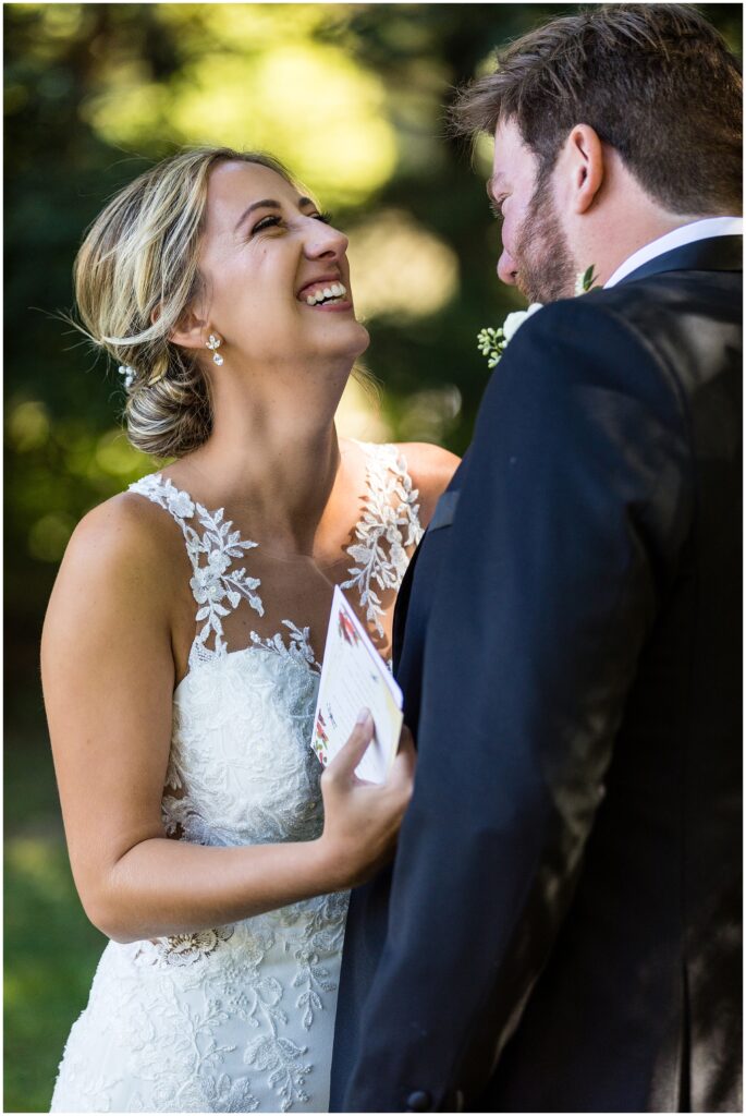 Bride and groom laugh together before wedding ceremony